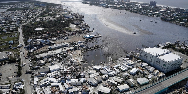 Damages boats lie on the land and water in the aftermath of Hurricane Ian, Thursday, Sept.  29, 2022, in Fort Myers, Florida. 